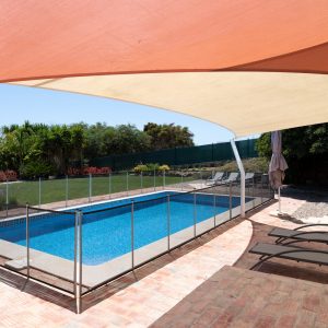 Fenced,Swimming,Pool,In,Garden,With,Sunbeds,Under,A,Shade
